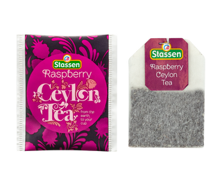 STASSEN Herbata - Raspberry Tea - ozdobne fioletowe opakowanie z motywem roślinnym.